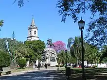 A park with many trees and a statue